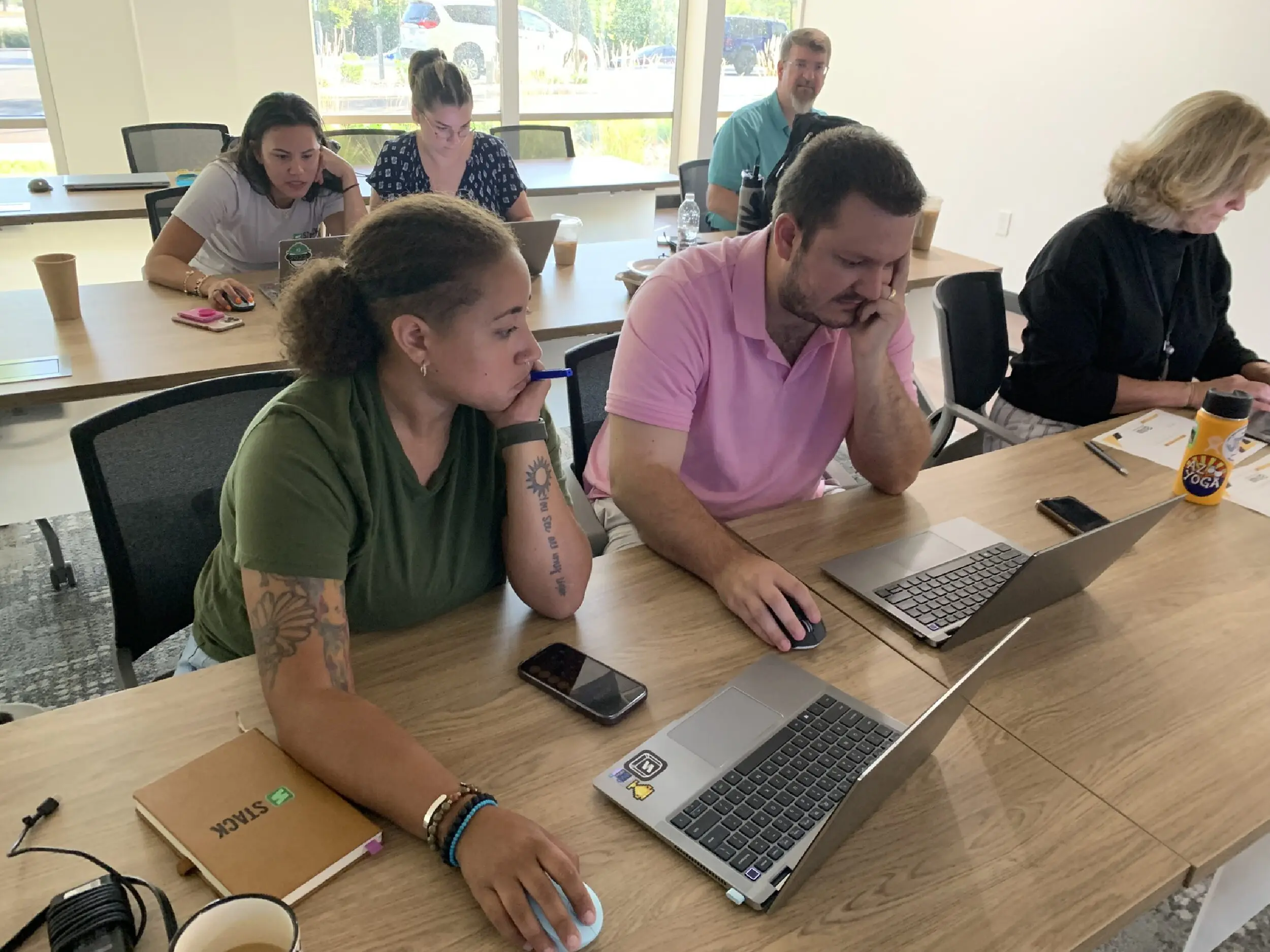 STACK Staff work on laptops to participate in the estimating workshop.