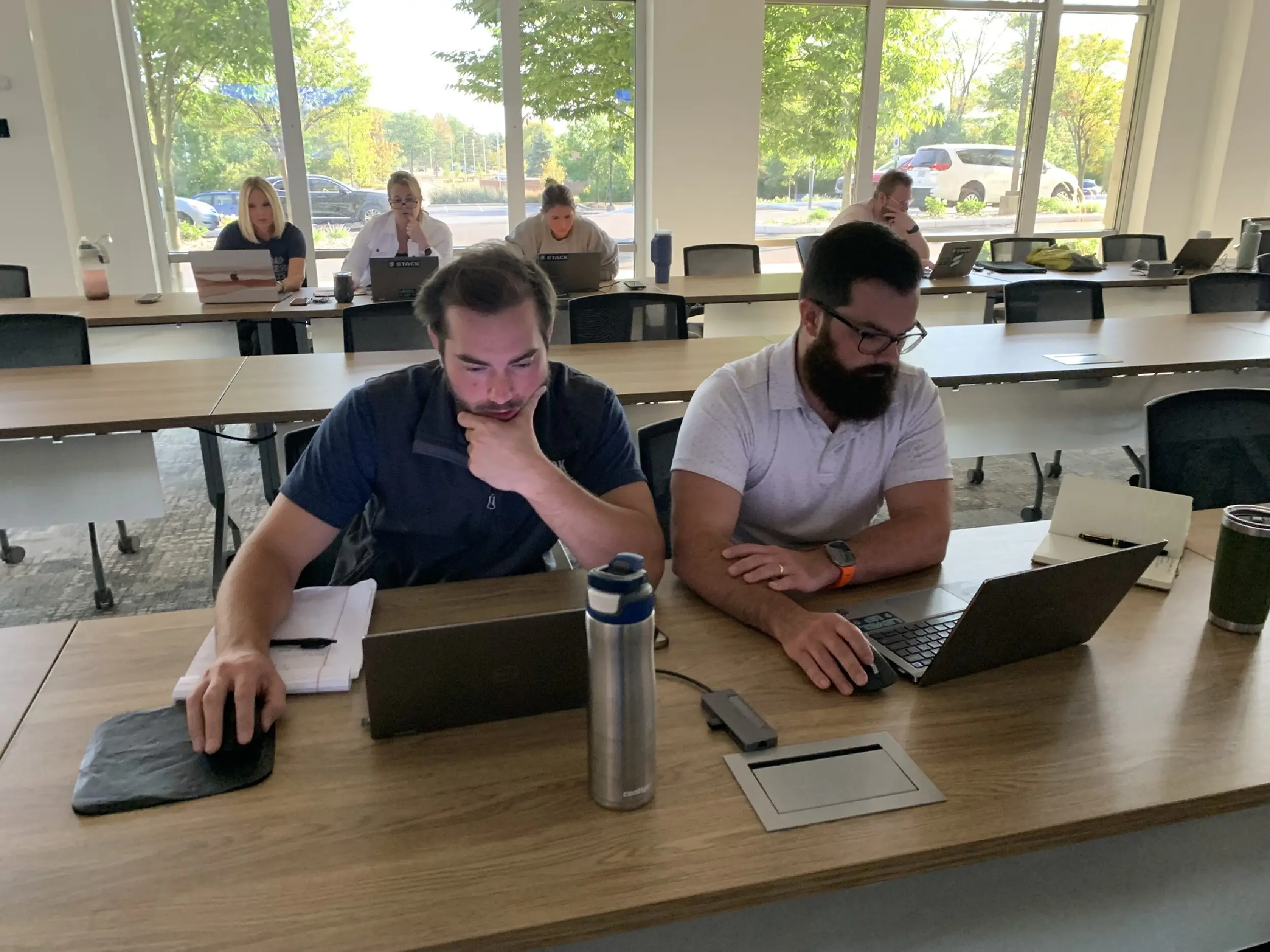 STACK Staff work on laptops to participate in the estimating workshop.