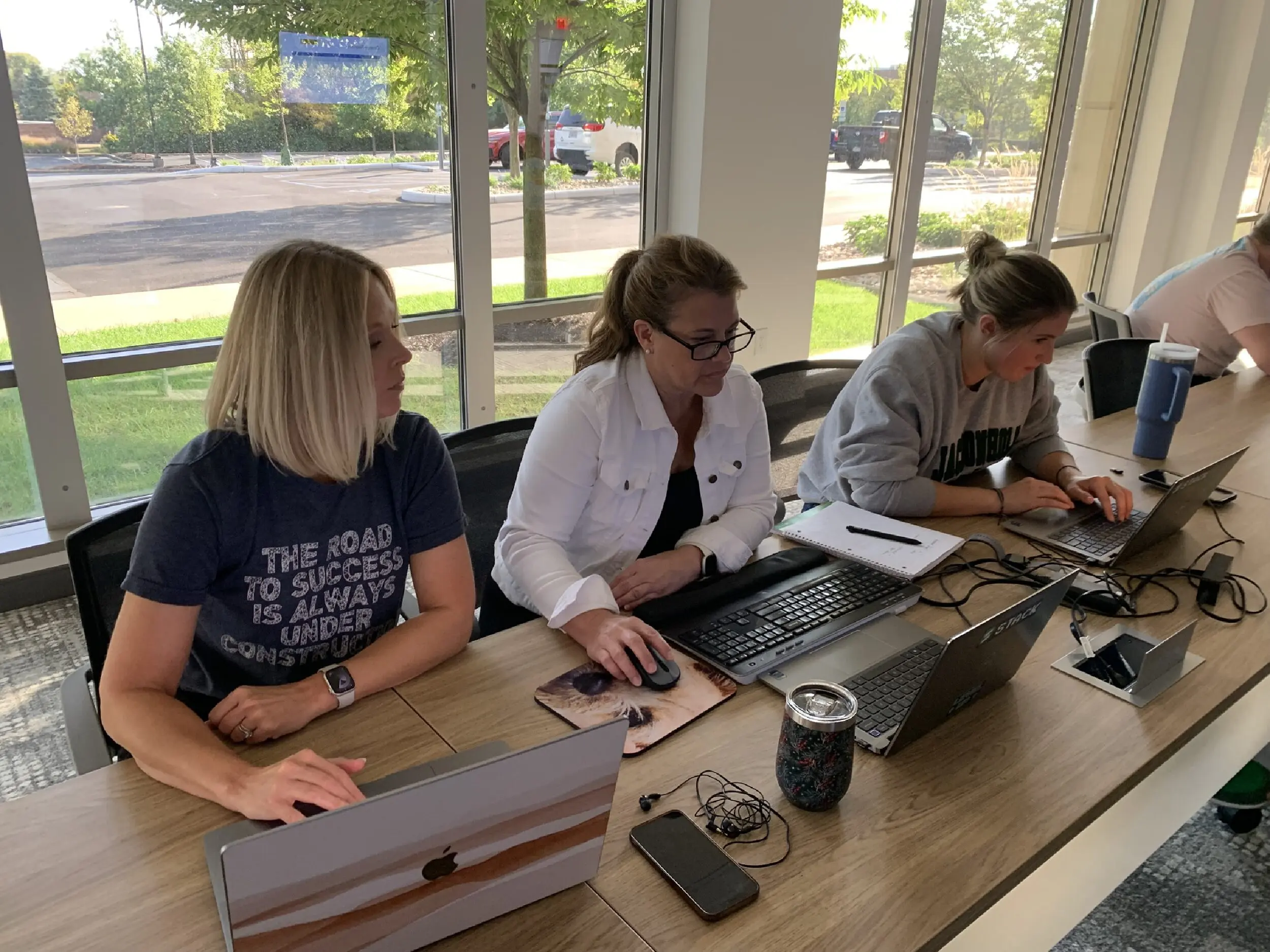 STACK Staff work on laptops to participate in the estimating workshop.