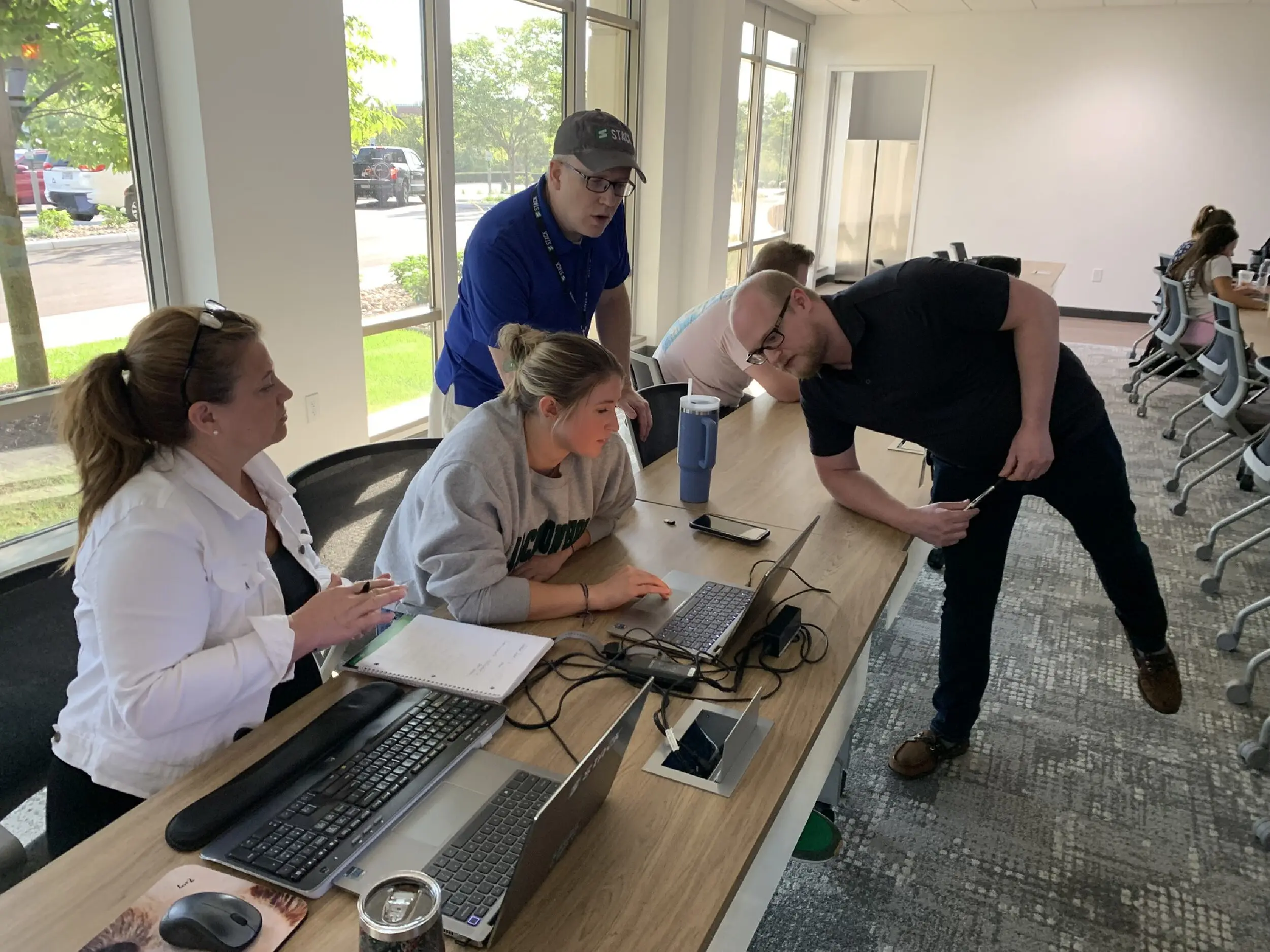 STACK Staff work on laptops to participate in the estimating workshop.